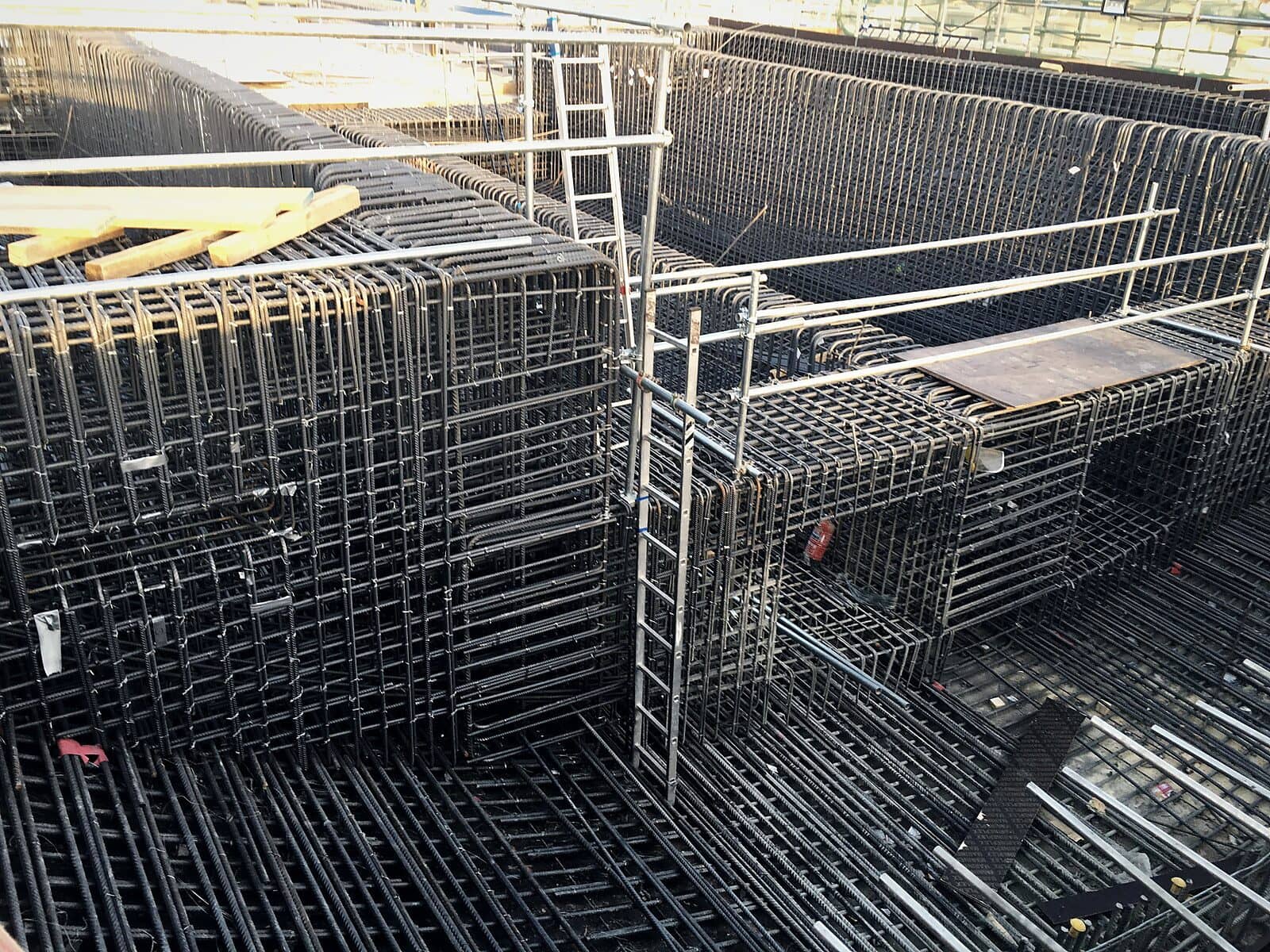 Wall reinforcement cages meeting at a junction, with access ladders