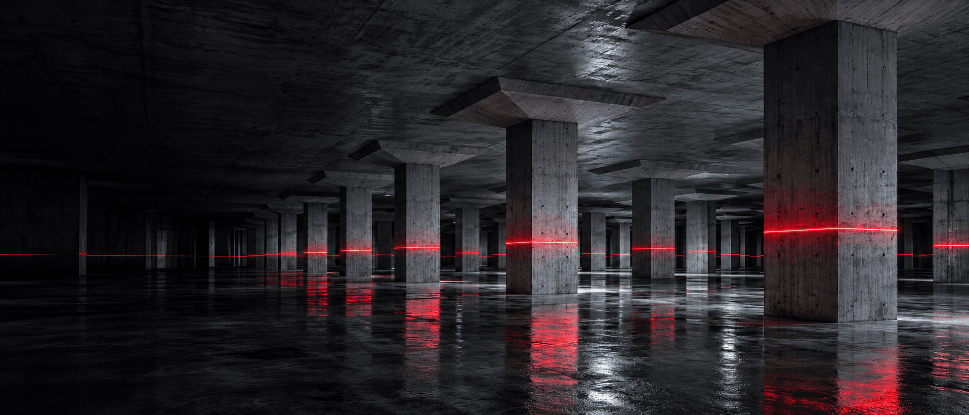 Concrete basement level with a red survey laser line across every column