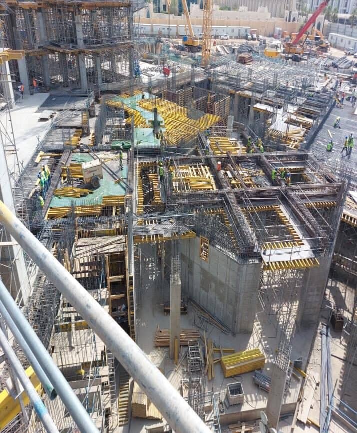 Building frame under construction seen from above, with slab formwork on several levels